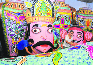 Workers prepare an effigy of Ravana in Mohali on Wednesday.