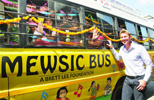 Australian fast bowler Brett Lee poses during the launch of a Mewsic and Education Bus at Australian High Commission in New Delhi on Wednesday