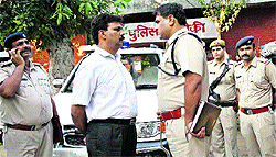The Superintendent of Police (in white shirt) and the DSP in front of the PGIMS hospital after a criminals escape in Rohtak on Wednesday
