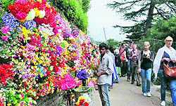 A vendor displays artificial flowers on the occasion of Navratris in Shimla on Wednesday