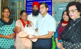 Deputy Commissioner Rajat Aggarwal hands over the newborn to members of the NGO in Ludhiana on Wednesday
