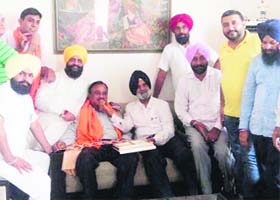 Ranjit Singh Talwandi, halka in charge, SAD, welcomes Anil Shukla, acting president of the Congress wing in Khanna, to the Akali fold on Wednesday