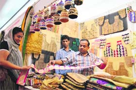 A vendor from West Bengal shows fabrics at Weaves Handloom Fabric Exhibition at Shehanshah Palace in Ludhiana