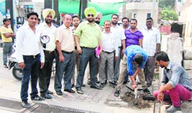 A team of the Municipal Corporation disconnects the water and sewerage connections of petrol pump at Rani Ka Bagh in Amritsar on Thursday.