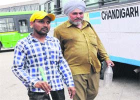 A visually challanged person being helped by a CTU driver during  a strike by the CTU Workers Union
