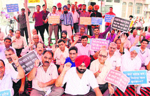 Residents demand construction of RUB at Sodal level crossing in Jalandhar on Thursday.