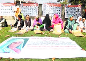 Members of the Association of Parents of Disappeared Persons during a silent protest at Partap Park in Srinagar on Thursday