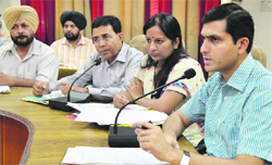 Deputy Commissioner Rajat Aggarwal (extreme right) addresses a meeting of officials on dengue in Ludhiana on Thursday. Photo: Inderjeet Verma 