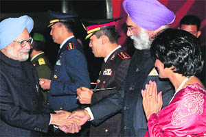 Prime Minister Manmohan Singh shakes hands with Ambassador of India to Indonesia Gurjit Singh upon his arrival at the Jakarta airport from Brunei on Thursday. 