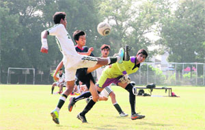 Players in action during a match in the Nemidass Memorial District Football League in Dehradun on Friday. 