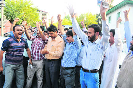 Employees of the state government protest in Srinagar on Friday. They sought the release of employees who were arrested during an agitation held a few days back. Tribune Photo: Amin War