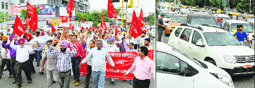 BSNL employees take out a protest march; and (right) vehicles stuck in a jam due to the protest in Ludhiana on Friday. 
