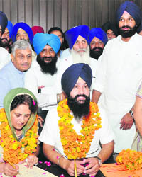  Revenue Minister Bikram Majithia (right) at the installation ceremony of Zila Parishad chairman Sarbjot Sabi in Hoshiarpur on Friday. 