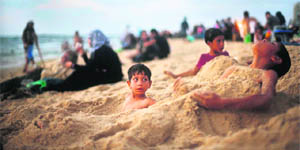 HAVING GOOD TIME:  An undated picture of Palestinian children playing in the sand on a beach in Gaza City. 