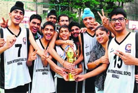 Cagers of Doon International School flash the victory sign after winning the Bhagwant Singh Memorial Inter-School Basketball Trophy at Vivek High School in Mohali on Saturday
