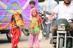 Child beggars wail for alms at a bus stop near Dogra chowk in Jammu on Saturday