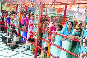 Divine rush: Devotees queue up to perform prayers at Mata Kali Temple in Jammu on Saturday