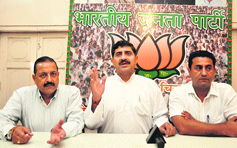 State BJP president Jugal Kishore Sharma (right) addresses mediapersons at the party office