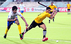 A match in progress between Indian Overseas Bank (in white) and Army Eleven during the 30th Indian Oil Surjit Hockey Tournament in Jalandhar on Saturday
