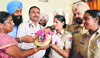 The abandoned girl child being handed over to the office-bearers of the NGO in Ludhiana. Photo: Inderjeet Verma