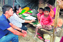 MAD volunteers interact with a woman at Bihari Basti in Dehradun on Sunday