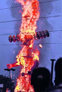 An effigy of Ravana ablaze at Sector 52 in Faridabad on Sunday.