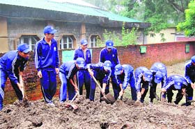 NSS volunteers clean the campus at Government Boys School in Dharamsala on Wednesday.