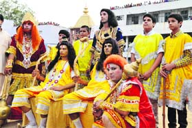 Artistes dressed as Lord Rama and Lakshmana watch as Ravana's effigy is set on fire at the Daresi Ground in Ludhiana on Sunday