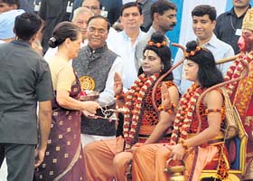 UPA chairperson Sonia Gandhi performs aarti of artistes enacting Lord Ram and Laxman during Dasehra celebrations in New Delhi on Sunday