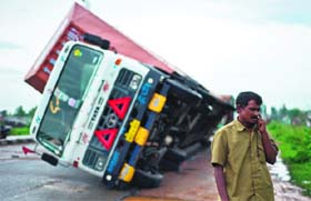 A truck carrying Toyota cars was overturned by strong winds on the national highway linking Andhra Pradesh and Odisha on Sunday