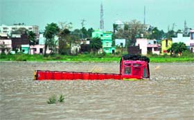 A truck is seen partially submerged in floodwaters following the cyclone in Gopalpur