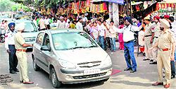 Traffic police navigating the traffic outside the Mata Kali Temple in Patiala on Sunday. The police ensured smooth flow of traffic this festival season