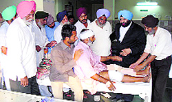 A delegation of Gujarat farmers visits an injured Jaswinder Singh at a hospital in Bhuj, Gujarat, on Sunday
