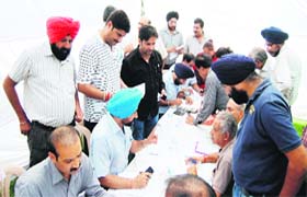 MC's House Tax Department officials at an awareness camp in Amritsar on Monday