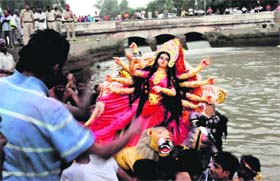 Devotees immerse Goddess Durgas idol in Sirhind canal on Monday.