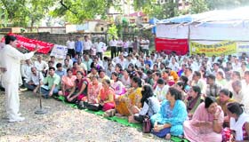 State government employees stage a demonstration in support of their demands at the Parade Ground in Dehradun on Monday
