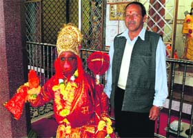 Seventyone-year-old Chandar Bhan in Hanuman attire, along with his close aide, Vijay Singh, in Mussoorie on Monday