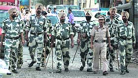 Members of the Anti-Riot Police Force take a round of the city market in Jalandhar on Monday.