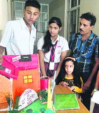 Students display their models at a science exhibition on the campus of DIPS, Suranussi, in Jalandhar on Monday.