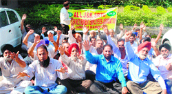 Members of the All J&K SRTC Volunteer Retired Employees Association stage a protest in Jammu on Monday. Tribune Photo: Inderjeet Singh