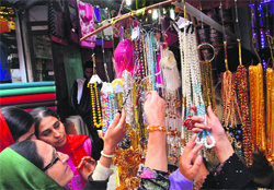 Women have a look at decorative items in Srinagar on Monday. Tribune photo: Amin War