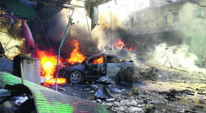 A car burns following an explosion in the town of Darkush in Idlib province of Syria on Monday. 