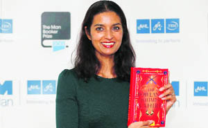 Man Booker prize shortlist nominee Jhumpa Lahiri poses with her book The Lowland in London on Sunday. 