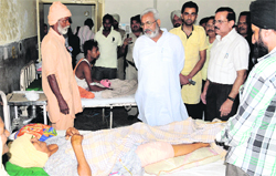 State Health Minister Surjit Kumar Jiyani interacts with a patient at the Civil Hospital in Bathinda on Tuesday. Tribune photo: Pawan Sharma