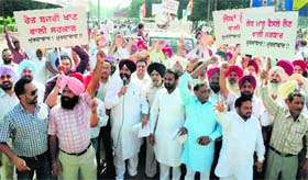 Congress activists stage a dharna against property tax at Phase VII in Mohali on Tuesday.