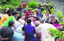 American team members interact with residents of Matli village in Uttarkashi district. A Tribune photograph