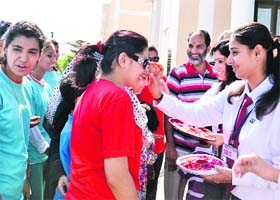 Playing host: Students of CT Public School welcome Punjab XI Pakistan hockey team players during their visit to the school in Jalandhar on Tuesday