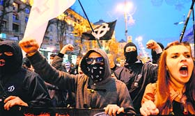 Ukrainian ultra-nationalists raise slogans during a march in Kiev on Monday to mark the 71st anniversary of the formation of the Ukrainian Insurgent Army