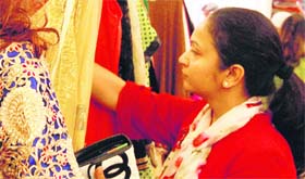 A woman looks at a designer wear collection at an exhibition in Amritsar on Wednesday.