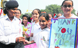 Students of The Millennium School, Mohali, thank a traffic policewoman for keeping the city roads safe on Thanksgiving Day in Chandigarh on Wednesday. Tribune photo: S Chandan